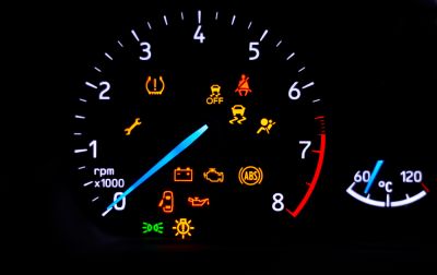 car speedometer with all the engine fault lights lit.